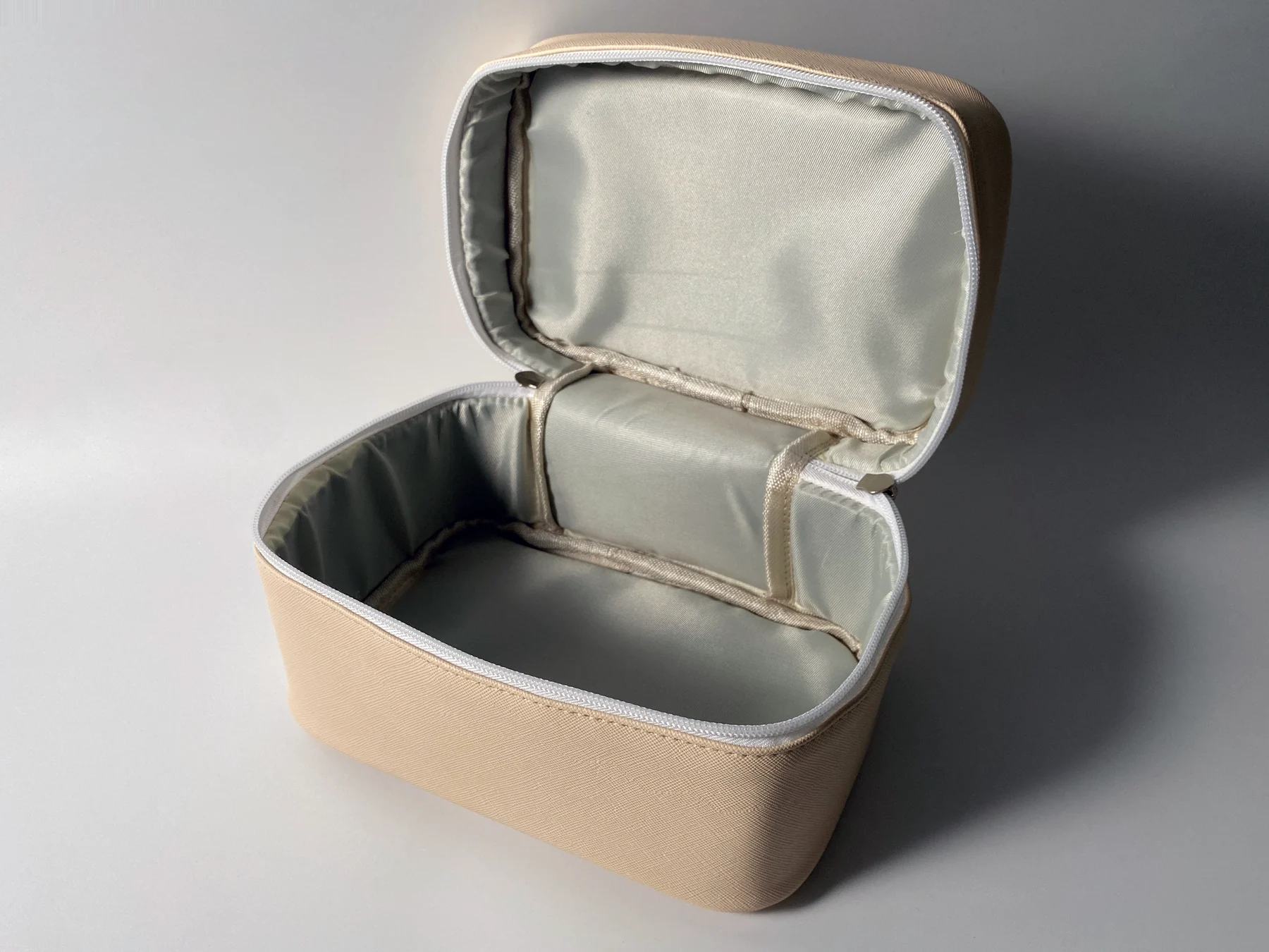 Open structured toiletry organizer showing lined interior and divider